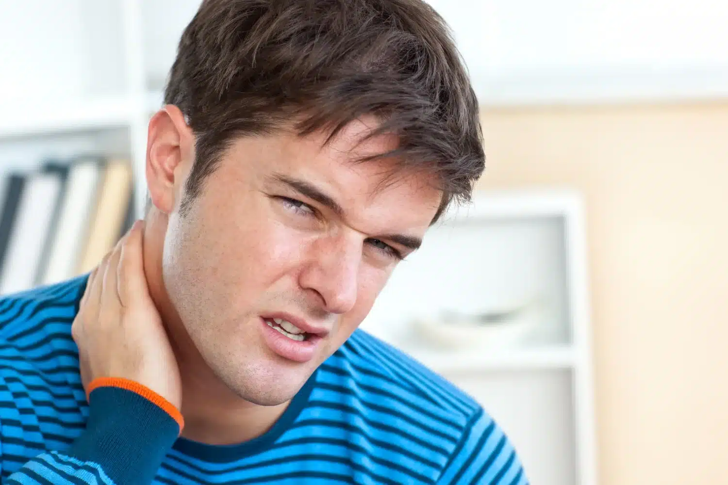 Person touching neck due to text neck posture strain