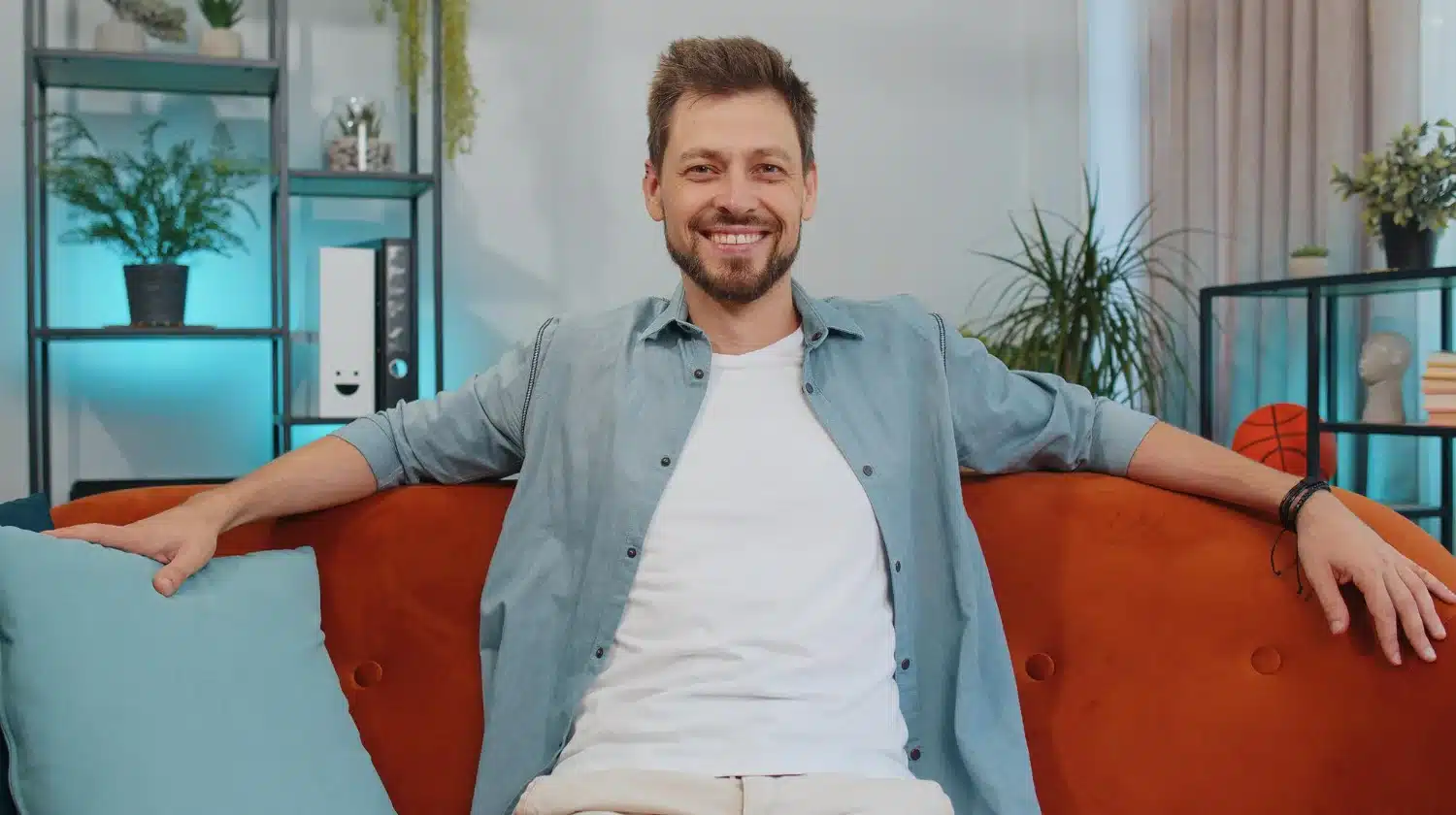 Relaxed man sitting comfortably after massage therapy session