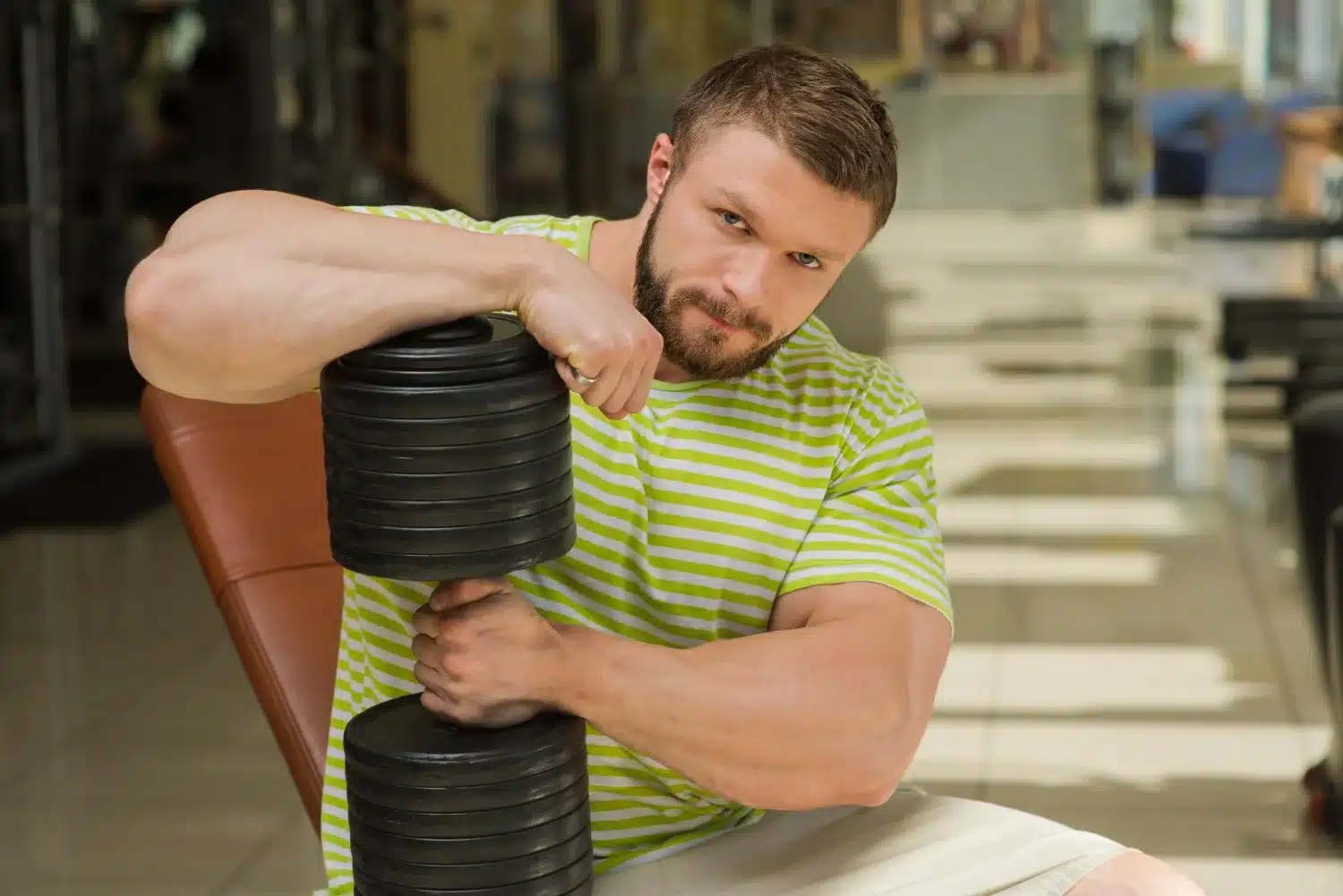 weightlifter experiencing muscle fatigue after heavy train