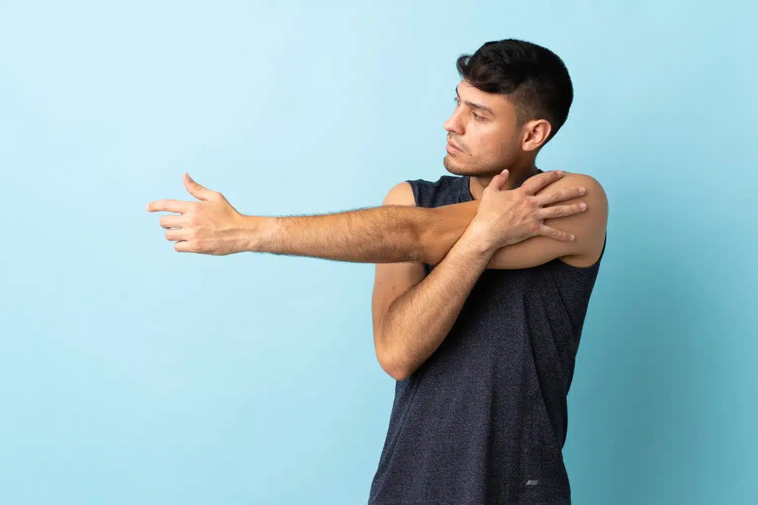Man performing a cross-body shoulder stretch