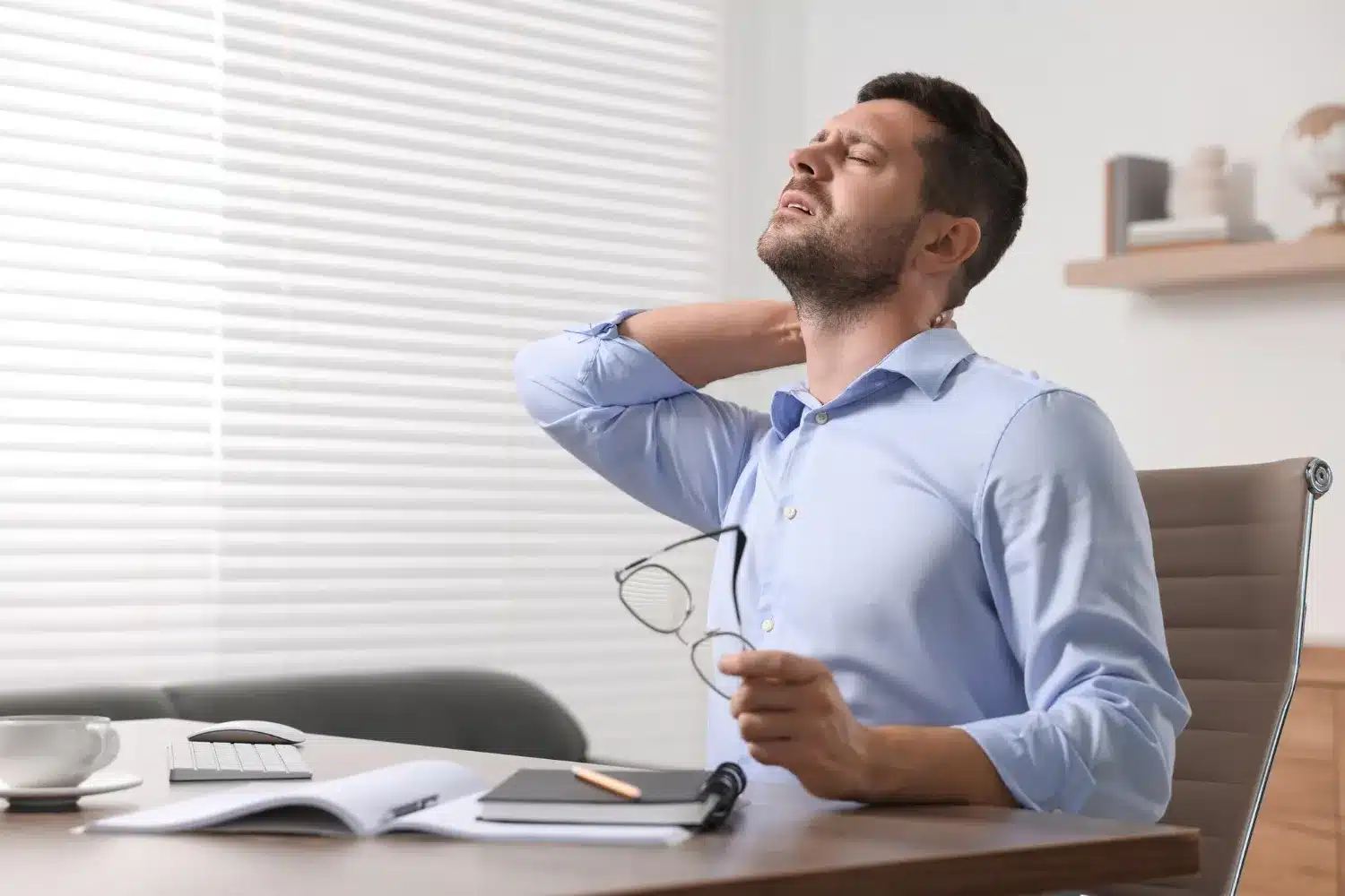 Office worker experiencing neck pain after prolonged computer work