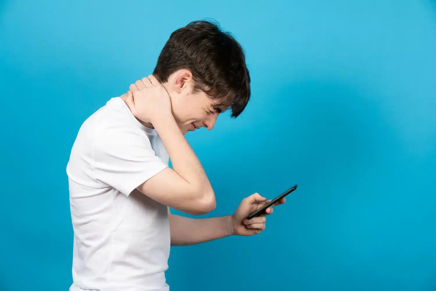 Man with forward head posture while using a smartphone