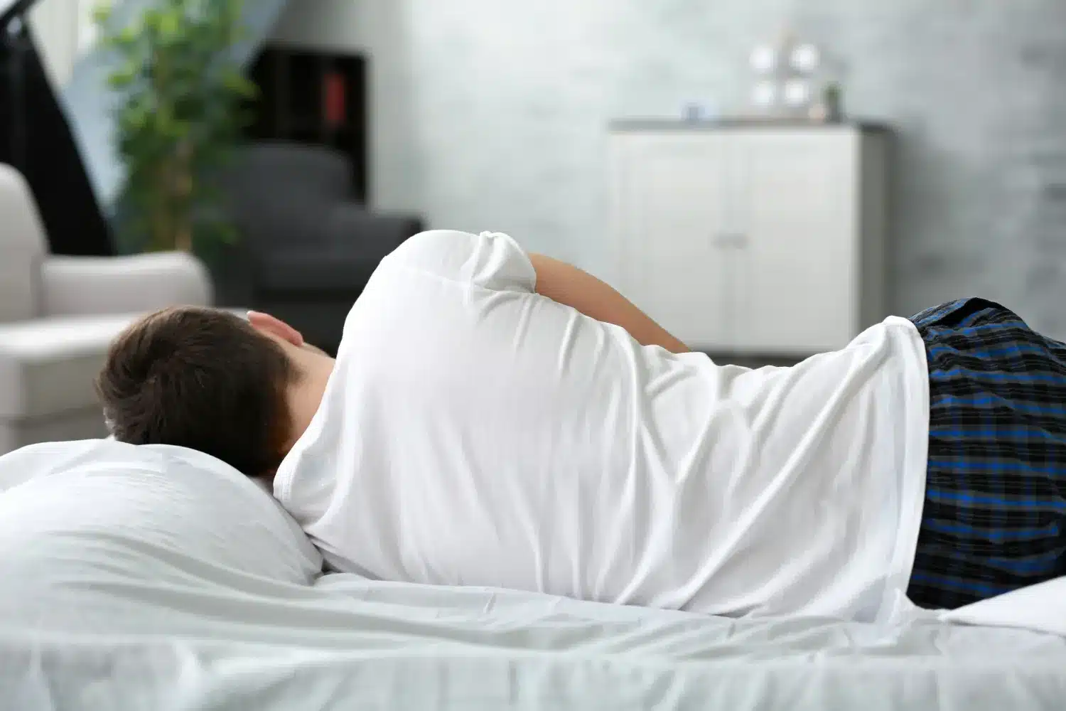 Person sleeping on their side with a pillow for support
