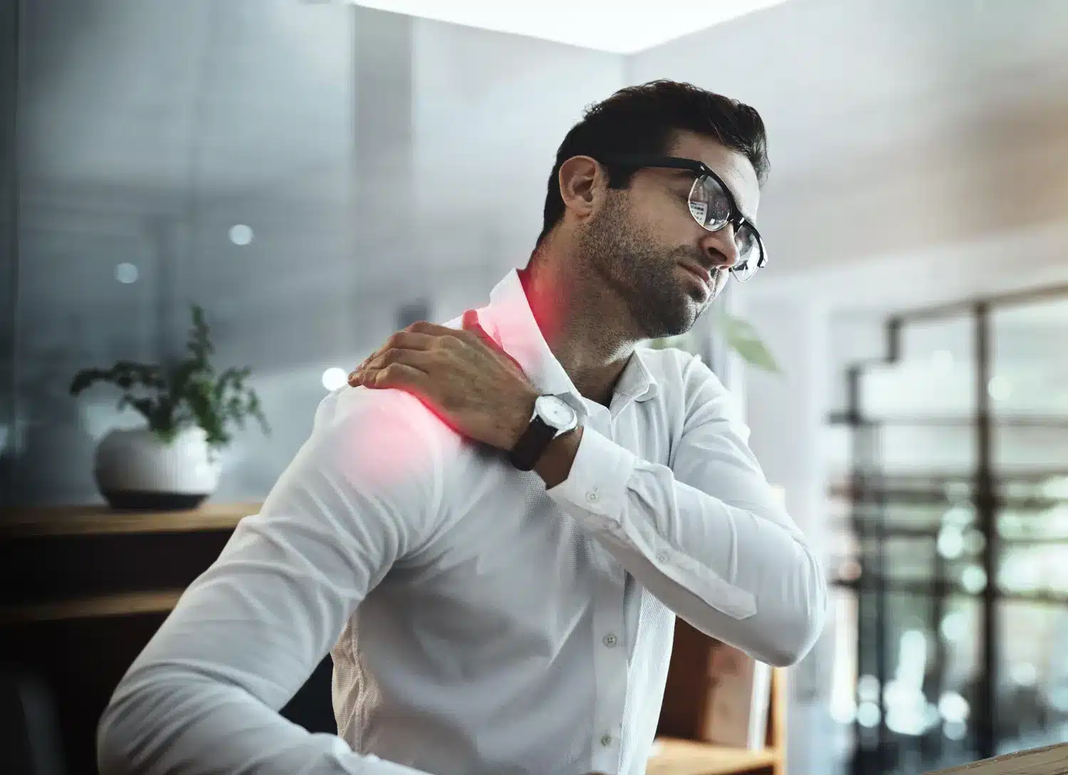 Man experiencing shoulder and neck pain while standing
